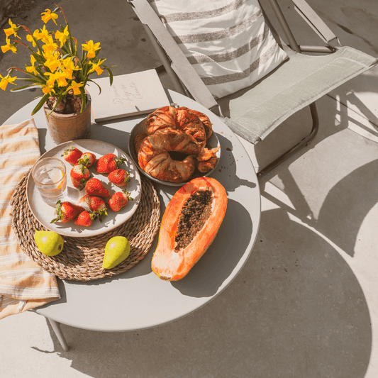 a picture of a plate with fruits on it, like strawberries and a papaya.